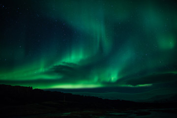 Northern lights above lagoon in Iceland