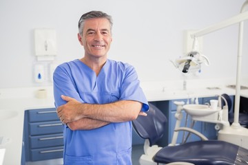 Portrait of a friendly dentist with arms crossed