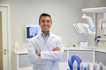 happy male dentist at dental clinic office