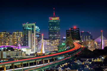 Rush hour traffic on Tobin bridge (aka Mystic River bride) heading towards Zakim bridge and Boston skyline by night