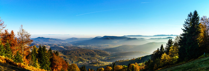 Aerial view of colorful autumnal mountains, foggy sunset