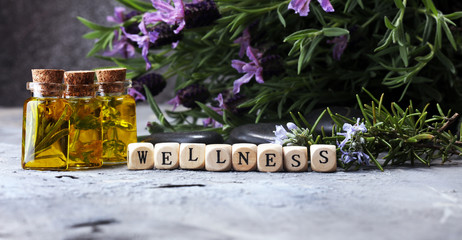olejek lawendowy w szklanej butelce na tle świeżych kwiatów.
