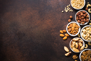 Nuts assortments on stone table top view.