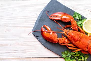 lobster with vegetable and lemon on black slate plate