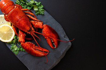 lobster with vegetable and lemon on black slate plate