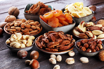 dried fruits and assorted nuts composition on rustic table