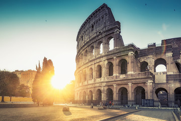 Koloseum w Rzymie, Włochy, o wschodzie słońca. Kolorowe tło podróży.