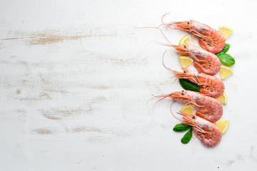 Duże krewetki z cytryną. Widok z góry. Wolne miejsce na Twój tekst. Na starym tle.