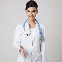 Przyjazny lekarz w mundurze. Szare tło.