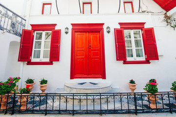 front of house with red windows on island mykonos in greece