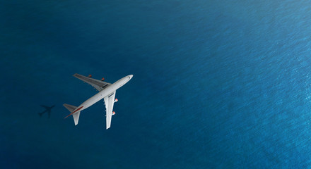 Aerial top view of Airplane flies over a sea, view from above