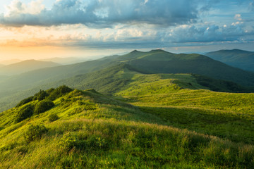 Stunning summer sunrise in the mountains. Beautiful green alpine meadow and blue sky. Polonina Wetlinska. Bieszczady. Poland