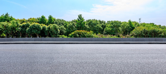 Asphalt highway and green forest with beautiful clouds landscape