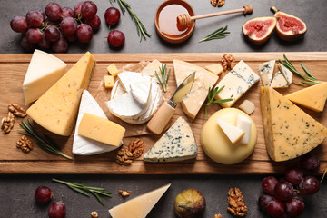 Flat lay composition with different types of delicious cheese on table
