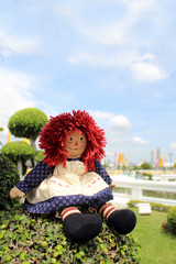 raggedy Anne doll sitting outside, Old Time Rag Doll, Ghost mystic doll. Scary horror doll