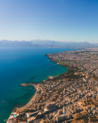 Window view of an airplane on the coast of Antalya with beautiful Taurus Mountains on the horizon, Turkey
