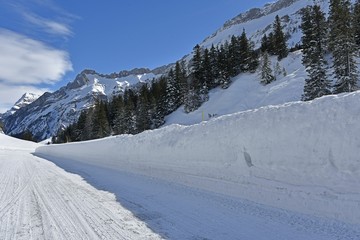 winter mountain road and snow walls