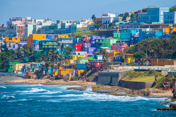 Colorful houses line the hill side overlooking the beach in San Juan, Puerto Rico.