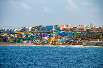 Colorful houses line the hill side overlooking the beach in San Juan, Puerto Rico.