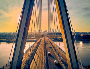 Beautiful panoramic aerial drone sunset view to Warsaw city center with skyscrapers and Swietokrzyski Bridge (En: Holy Cross Bridge) - is a cable-stayed bridge over the Vistula river in Warsaw, Poland