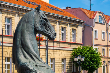 Historic horse statue, symbolic city emblem at the Plac Wolnosci square in the Old Town quarter of Konin, Poland