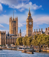 Big Ben and Houses of Parliament with boats on the river in London, England, UK