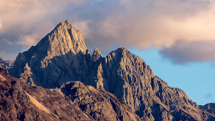 Close up of snow mountain in the early morning time, sunrise, with bright blue sky and copy space