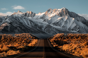 View of road leading towards snowy mountains