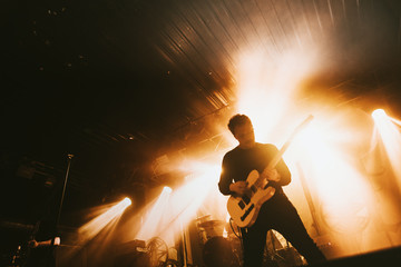 Guitarist playing electric guitar in a rock concert