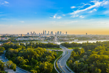 Beautiful panoramic aerial drone view to the Center of modern Warsaw city with silhouettes of skyscrapers in in the rays
