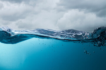 The deep blue sea at the time of the storm can be seen from under the water. Abstract wave blur under water
