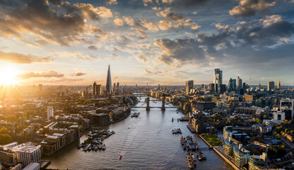 Wide panoramic view to the modern skyline of London, United Kingdom, along the Thames river during sunset time