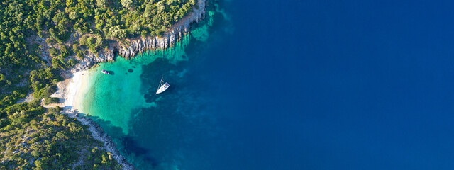 Aerial drone top down ultra wide photo of luxury yacht anchored in tropical exotic island turquoise sea