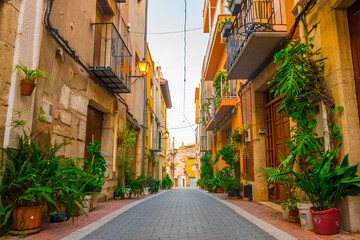Càlig, Baix Maestrat, Valencian Community, Spain. Beautiful flowery historic street (old town). Traditional and typical spanish village. 