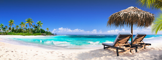 Chairs In Tropical Beach With Palm Trees On Coral Island