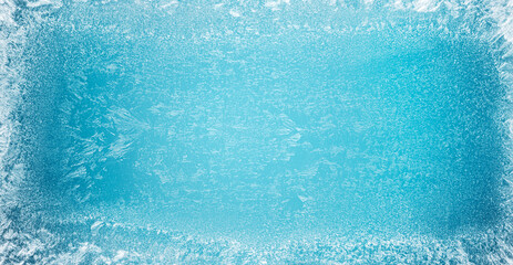 Frost patterns on frozen winter window as a symbol of Christmas wonder. Christmas or New year background.