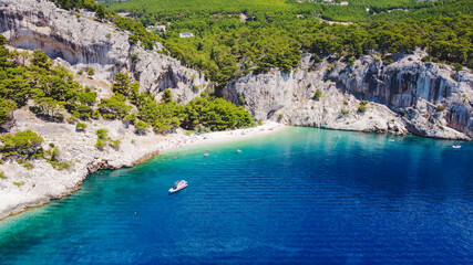 This is a beautiful coastal beach in Makarska, Croatia. The turquoise waters embrace the sun-kissed sand and the powerful waves crashing against the shore offer a peaceful escape from the busy world.