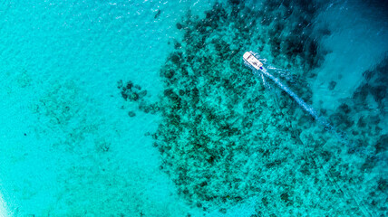 Aerial view to the small islands surrounded by cristal clear waters around Maldives