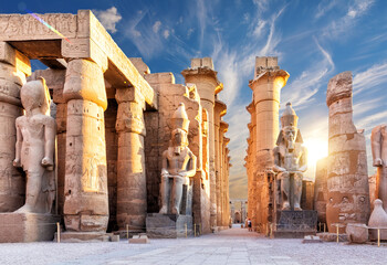 Columns and statues of the Luxor temple main entrance, first pylon, Egypt
