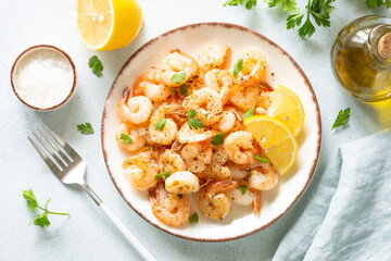 Shrimps with spices in craft plate at white stone table. Top view.