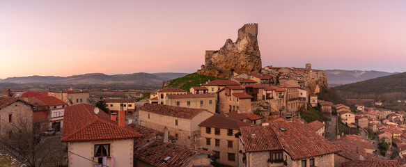 Panoramic landscape of the medieval village of Frías with old stone buildings and castle in the tophill at sunset, Burgos, Castile and Leon, Spain