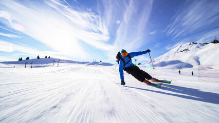 professional skier skiing on slopes in the Swiss alps towards the camera