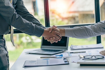 business people shaking hands with customers in a modern conference room The team leader meets the group to greet each other. Handshake showing trust and respect, financial accounting concept