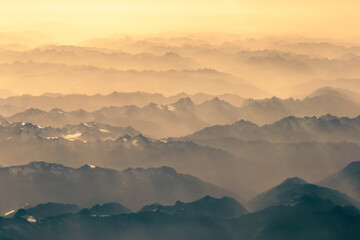 Aerial view of morning sunlight on Summer Alps. 