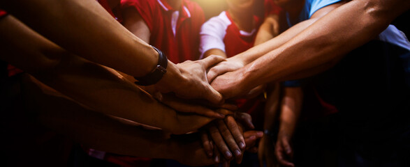 Sports team showing unity with their hands together