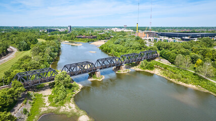 Train bridge over Scioto River with forested area aerial