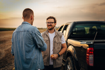 business partners meets on corn field