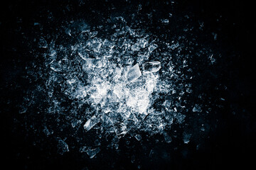 Ice, crushed on a black background. Shards of crushed ice spreading away. The explosion of ice.