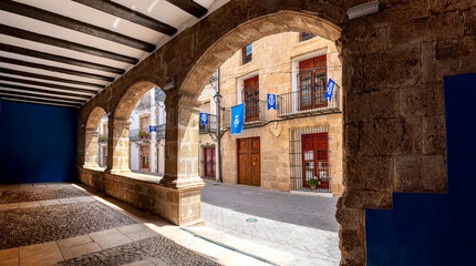 View through stone arches to a traditional old town street in Benissa, Costa Blanca, Spain