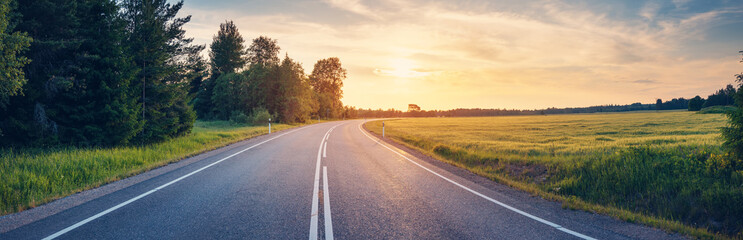Panoramic view of the empty winding road on sunset.